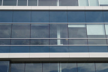 office building aluminum and glass gray white blue skyscraper