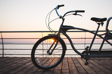 Fototapeta na wymiar Picture of a tandem bicycle outdoor on sunset or sunrise