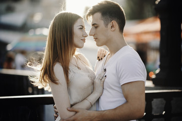 Portrait of young couple in love, enjoying the sunset in city