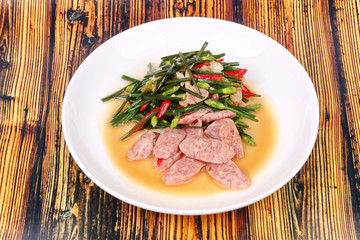 Fried Chinese chives with Thai sour sausage .