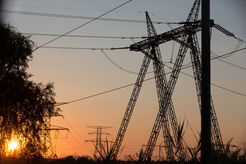 Transmission power line silhouette on sunset