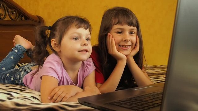Children with laptop.