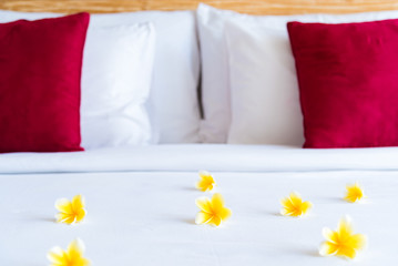 Hotel room with bed and flower arrangement