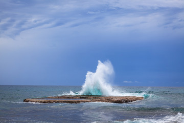 Waves crashing on rock