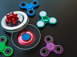 Popular colourful fidget spinner toy in a gift box on a black background