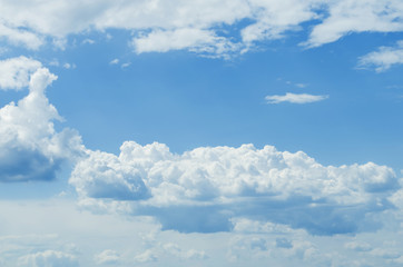 Naklejka na ściany i meble Sunny blue sky background with partial fluffy clouds Photo