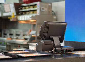 Cash and order desk and kitchen equipment on back in fast food restaurant - obrazy, fototapety, plakaty