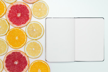 slices of oranges, lemons and grapefruits on vintage white table. Citrus fruit background. healthy eating with natural vitamins. Top view with copy space