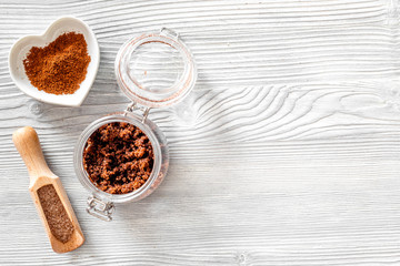 Aroma spa set. Coffee scrub, coffee grains, coffee spa salt on wooden table background top view copyspace