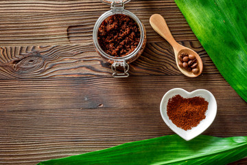 Skin care. Coffee scrub on wooden background top view copyspace