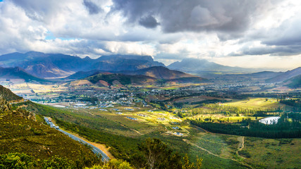 Fototapeta na wymiar Franschhoek Valley in the Western Cape of South Africa with its many vineyards as seen from Franschhoek Pass in the Middagskransberg between the Franschhoek Valley and the Wemmershoek Mountains