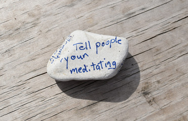 Rock with inspirational sentiments written on it