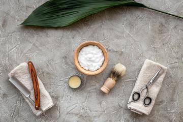 Preparing for men shaving. Shaving brush, razor, sciccors, foam on grey stone table background top view