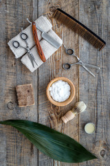Barber workplace. Shaving brush, razor, foam, sciccors on wooden table background top view