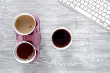 Coffee to go. Coffee cups with cover on wooden table backound top view copyspace