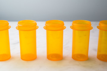 Five Prescription Vials, lined up on white