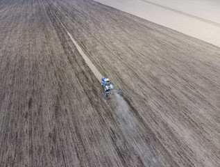 Cultivation of soil for the sowing of cereals. Tractor plows the soil on the field
