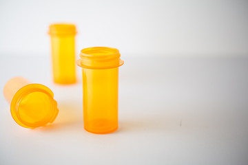 Shallow depth of field on 3 prescription vials on white, suitable for  representing healthcare or substance abuse