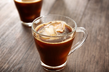 Glass cup of cold brew coffee on wooden table