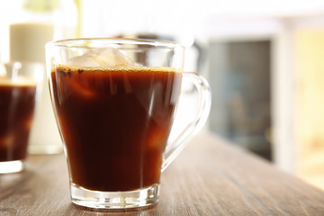 Glass cup of cold brew coffee on wooden table