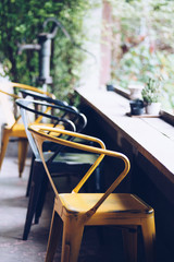 Empty seats at coffee shop, wooden counter table.