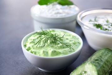 Delicious yogurt sauce in bowl on dark background