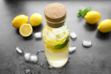 Bottle of fresh lemonade on table