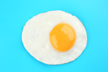 Delicious sunny side up egg on color background