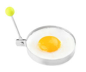 Fried sunny side up egg in round mold isolated on white