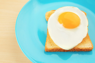 Plate with delicious sunny side up egg and toast, closeup