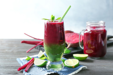 Glass of mixed vegetable smoothie on wooden table