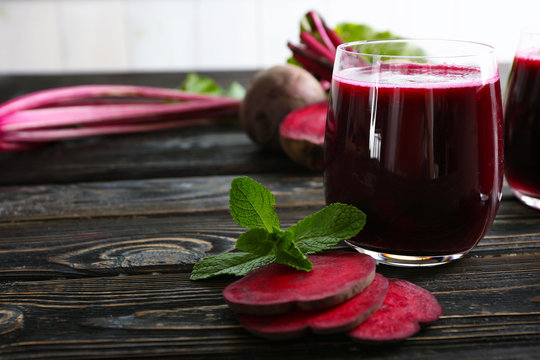 Healthy beet smoothie on wooden table