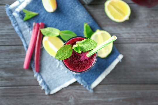 Glass of fresh beet vegetable smoothie on wooden table