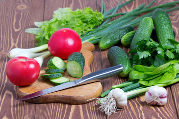 Свежие огурцы,помидоры и зелень,готовка полезной еды из овощей