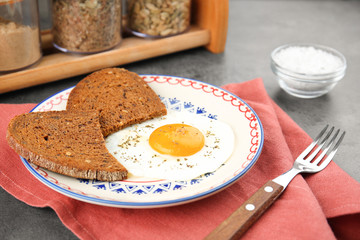 Homemade fried egg with bread on plate