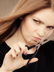 Crazy girl with scissors. Hairdresser in action.