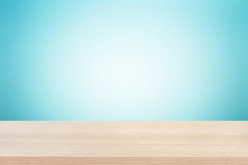 Wood table top on gradient light blue background