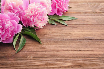 Beautiful peony flowers on wooden background