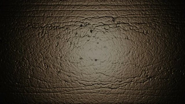 A computer generated animation of a black wall with scratches and indents together with flashing and flickering colored lights