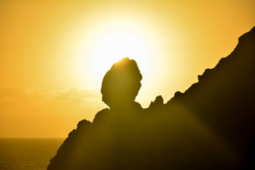 Sunrise and rock silhouette