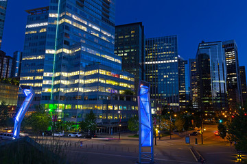Night skyline of Vancouver downtown near waterfront, British Columbia, Canada. Illuminated modern building in the city after sunset.