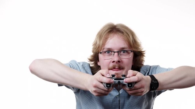 Videogame addicted guy playing with controller console. Young male gamer with pad joystick playing games, on white 4K ProRes HQ codec