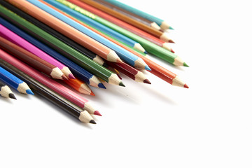 Many different colored pencils on white background
