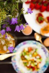 Fresh Summer Outdoor Romantic Breakfast in Park with Eggs, Berries, Flowers