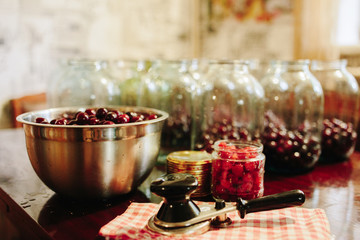 Old machine for rolling metal caps during storage. Preservation of compote from berries