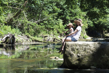 Mother and daughter playing in mountain stream