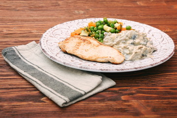 Turkey fillet with mushrooms in cream sauce and vegetables