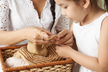 Obraz na płótnie Canvas Crocheting with daughter