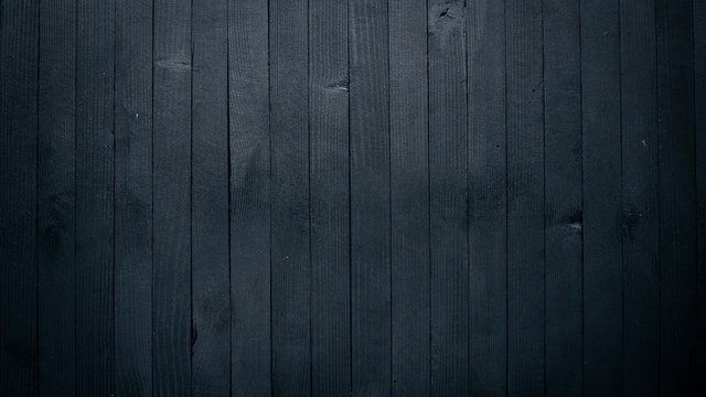 Wooden black texture surface. Top view. Free space for your text.