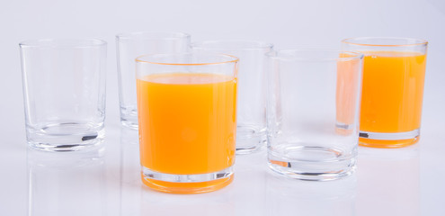 Orange juice in glasses on white background.